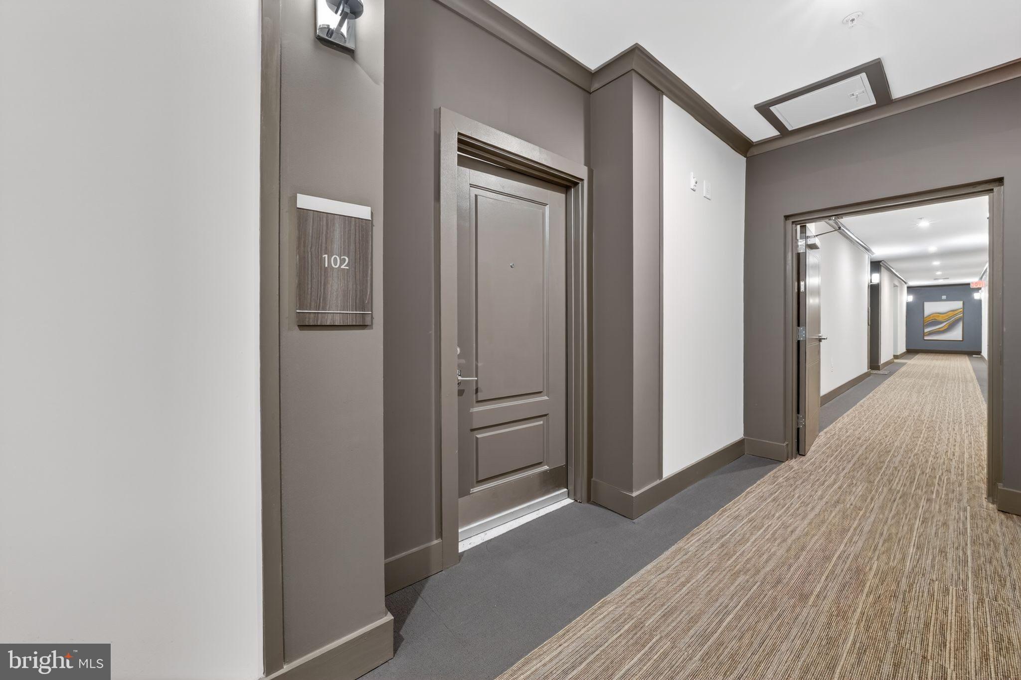 2319 Field Point Road, Unit 102 Herndon, VA 20171 - Photo 3 of 20 a view of a hallway with wooden floor