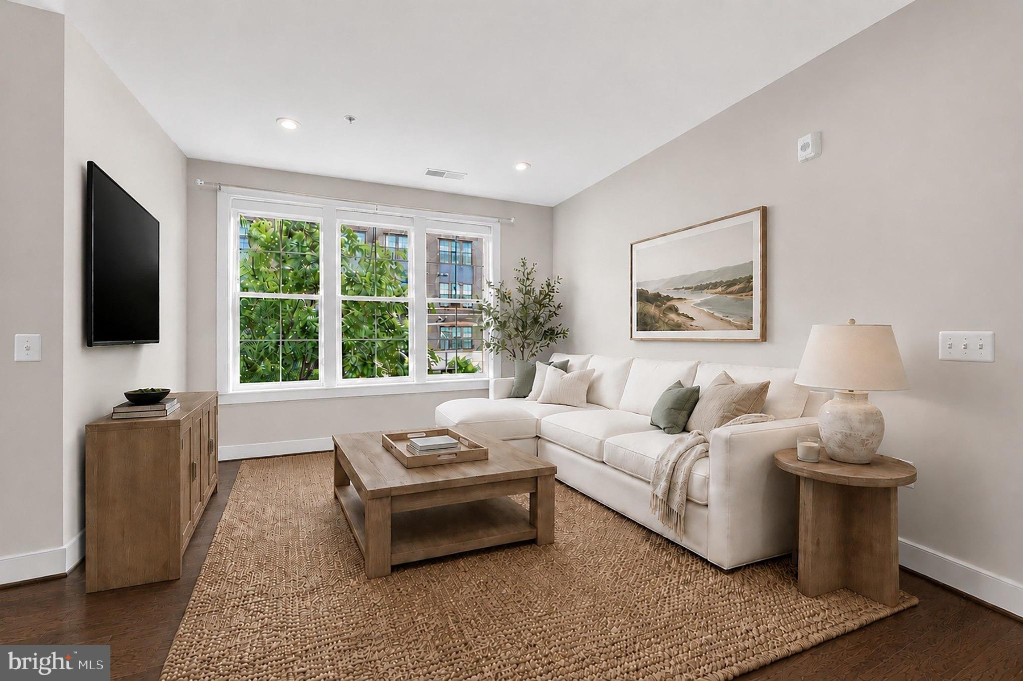 2319 Field Point Road, Unit 102 Herndon, VA 20171 - Photo 9 of 20 a living room with furniture and a flat screen tv
