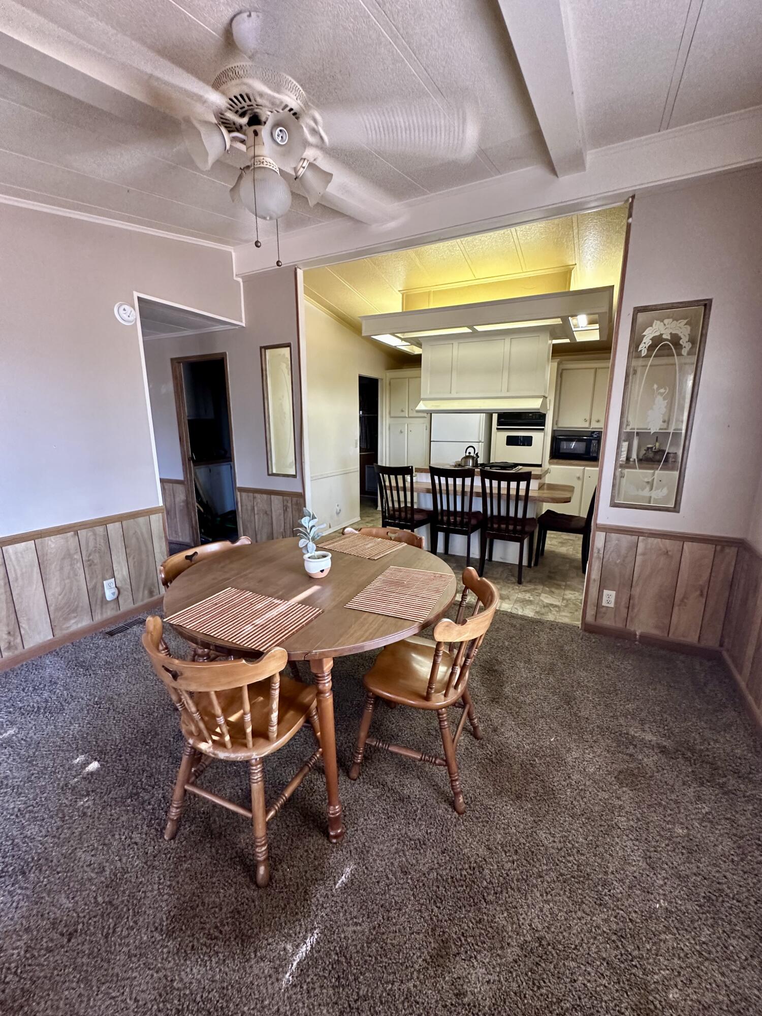 5261 North Intake Boulevard Blythe, CA 92225 - Photo 7 of 14 a dining room with a wooden table and chairs