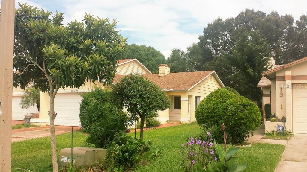 a front view of a house with garden