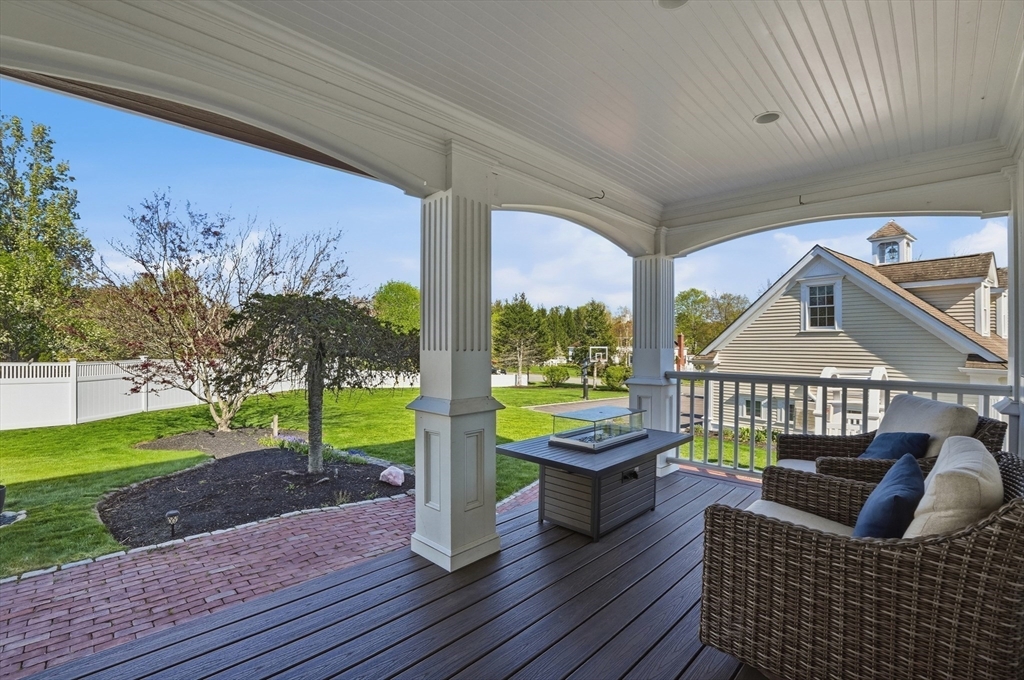 183 Whiting Street Hanover, MA 02339 - Photo 36 of 42 a roof deck with table and chairs and wooden floor