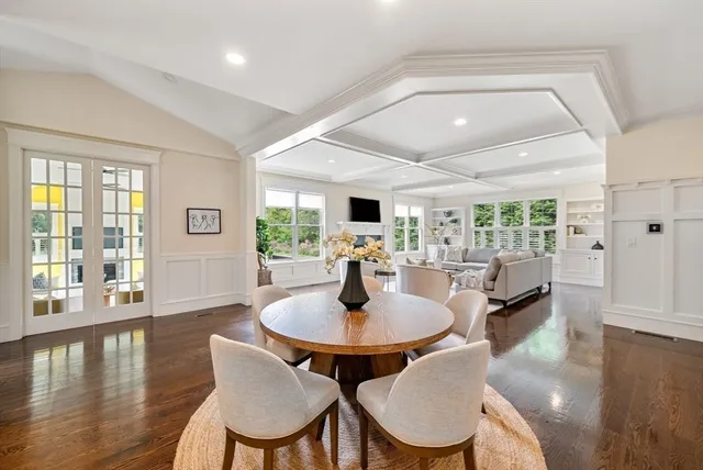 a dining room with furniture window and wooden floor
