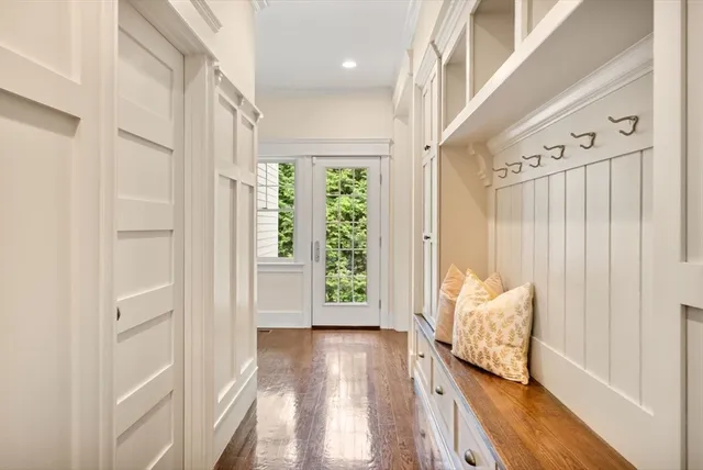 a view of a hallway with wooden floor and windows