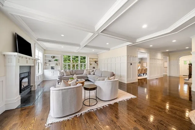 a living room with furniture a flat screen tv and a fireplace