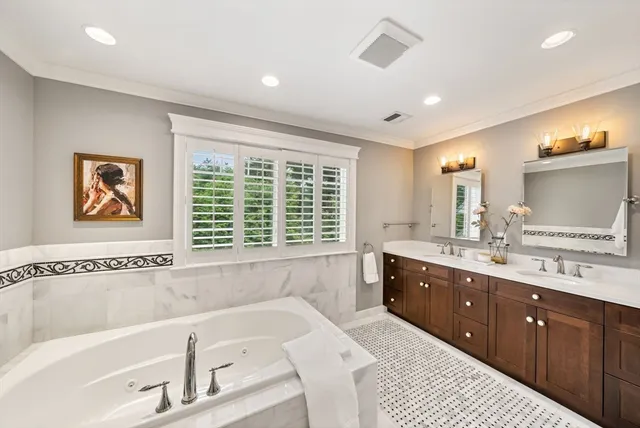 a spacious bathroom with a large tub and sink