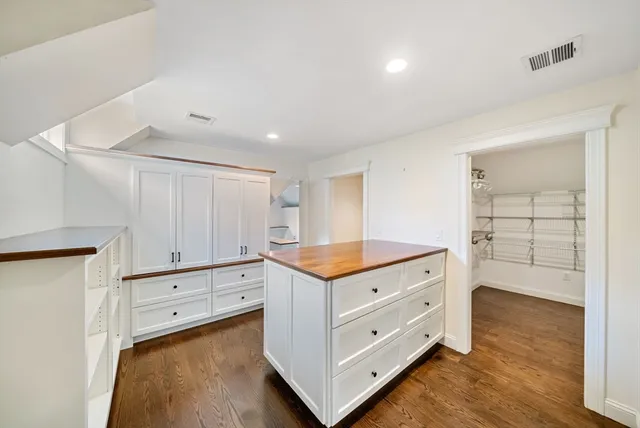 a kitchen with granite countertop white cabinets and white appliances