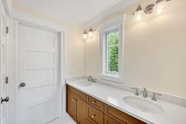 a bathroom with a double vanity sink and a mirror