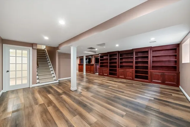 a view of an empty room with a fireplace and a window