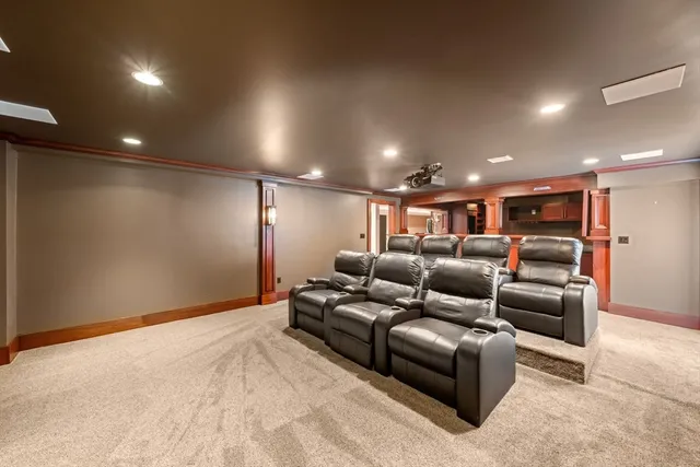 a media room with lots of chairs and a projector screen