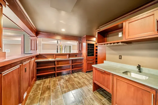 a kitchen with stainless steel appliances kitchen island granite countertop a sink and cabinets