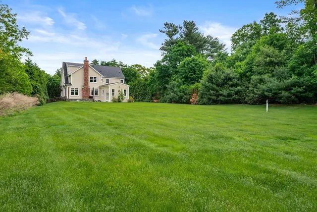 a house with a green field in front of it