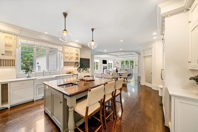 a kitchen with a table chairs stove and wooden floor