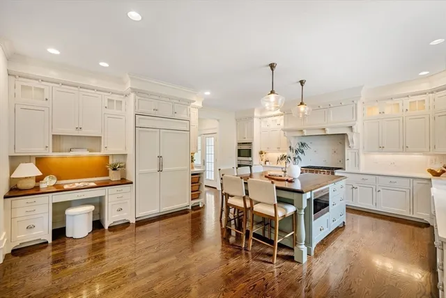 a kitchen with a table chairs sink and cabinets