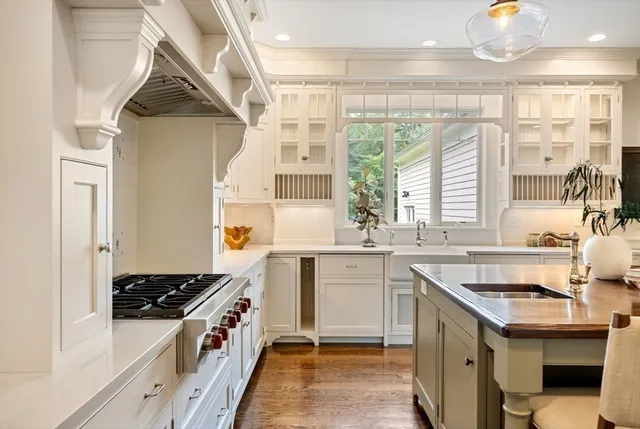 a kitchen with a sink stove and cabinets