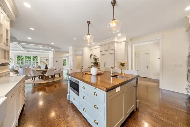 a kitchen with kitchen island a sink stove and wooden floor
