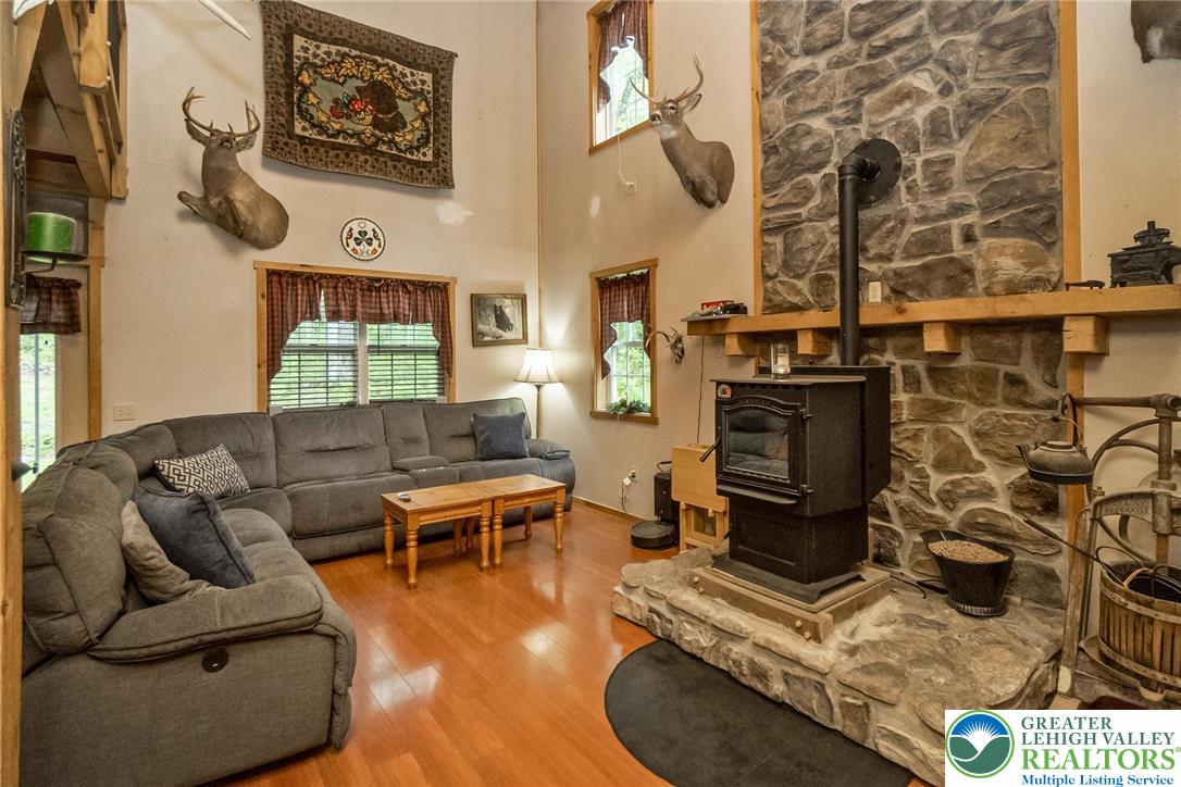 9223 North Loop Road Slatington, PA 18080 - Photo 13 of 60 a living room with furniture a rug and a fireplace