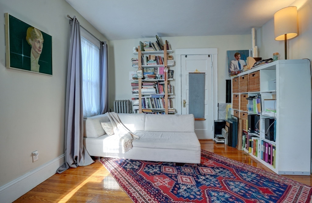 77 2nd Street, Unit 2 Medford, MA 02155 - Photo 11 of 18 a living room with furniture and a book shelf