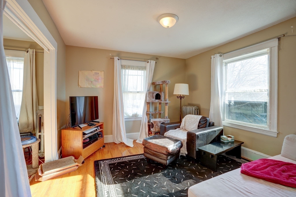 77 2nd Street, Unit 2 Medford, MA 02155 - Photo 12 of 18 a living room with furniture and a flat screen tv