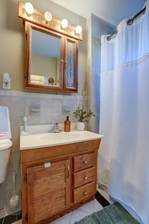 a bathroom with a sink vanity and a mirror