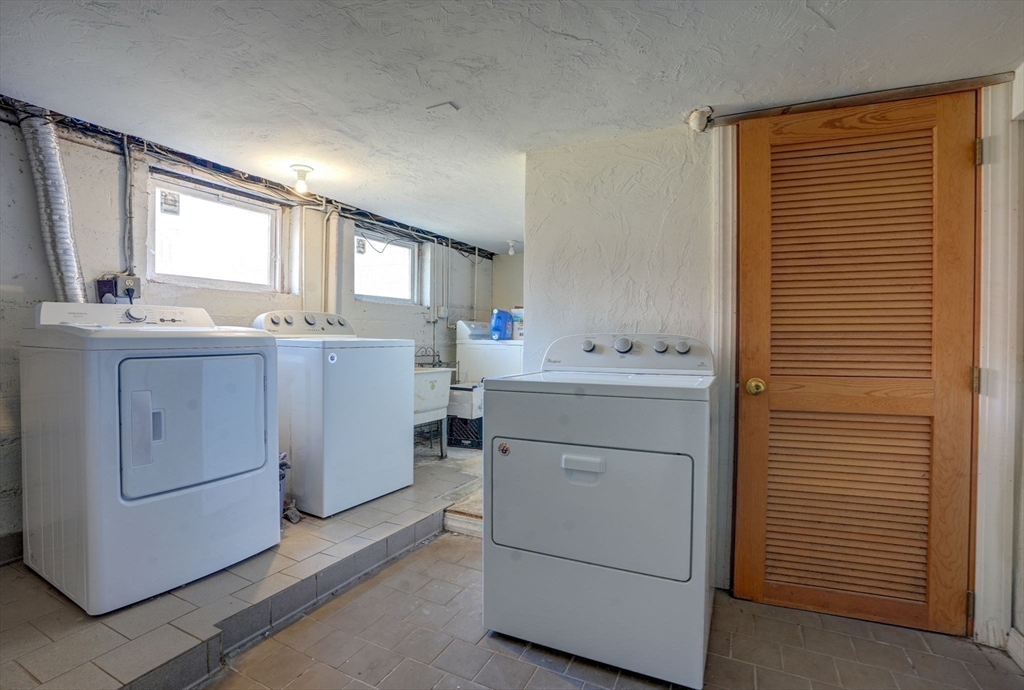 77 2nd Street, Unit 2 Medford, MA 02155 - Photo 15 of 18 a utility room with cabinets washer and dryer