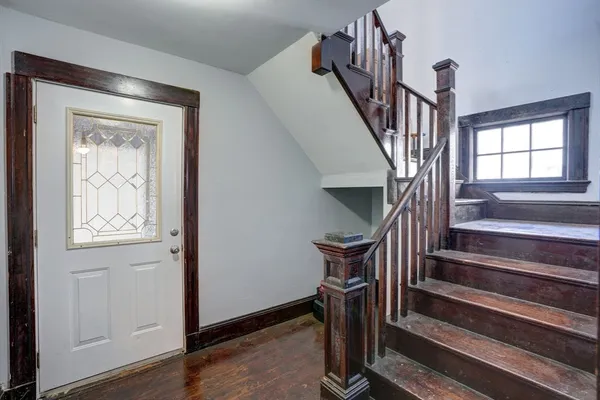 a view of staircase with wooden floor and a window