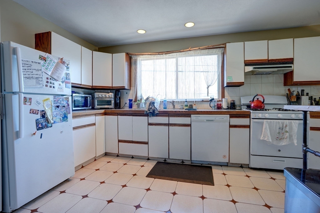 77 2nd Street, Unit 2 Medford, MA 02155 - Photo 2 of 18 a kitchen with white cabinets and white appliances