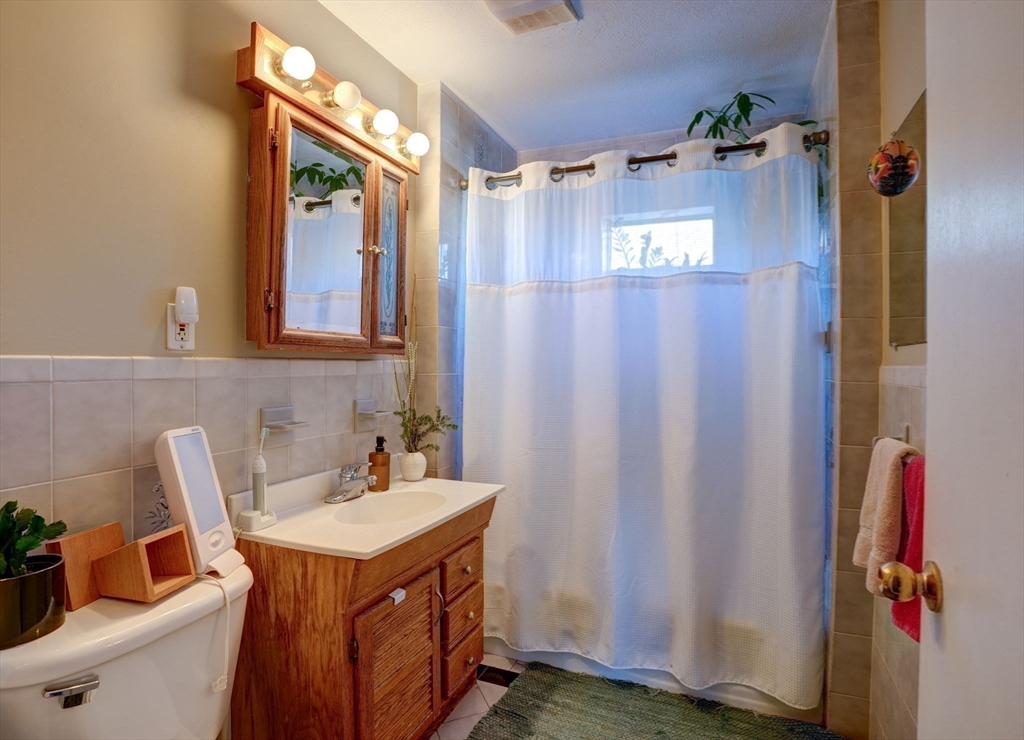 77 2nd Street, Unit 2 Medford, MA 02155 - Photo 6 of 18 a bathroom with a sink and a mirror