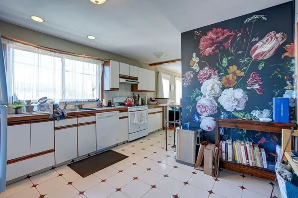 a kitchen with appliances cabinets and a table