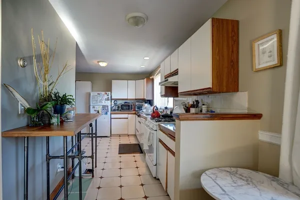 a kitchen with cabinets a sink and appliances