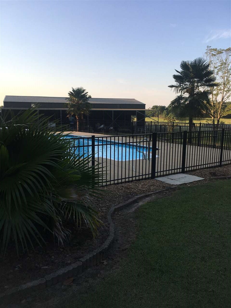 20 Butler Lane Collins, MS 39428 - Photo 14 of 25 18x36 inground with 1340 sq. ft. concrete apron with aluminum fence. Two lockable gates.