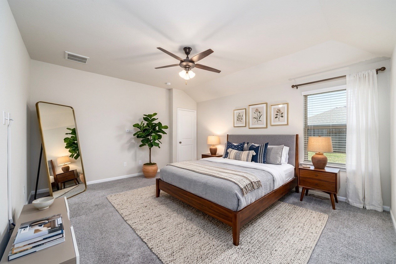 8307 Oakleaf Meadow Court Rosharon, TX 77583 - Photo 16 of 39 a bedroom with a bed and a chandelier