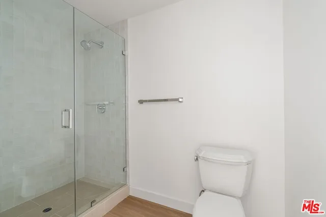 a bathroom with a toilet and a shower