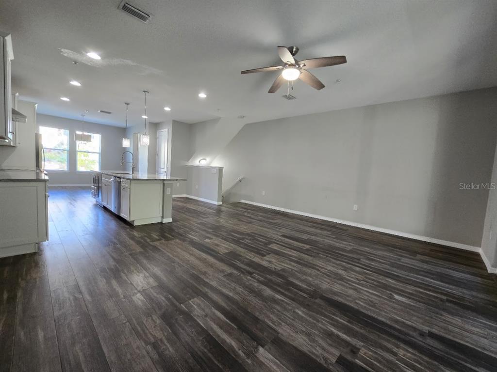 807 Callista Cay Loop Tarpon Springs, FL 34689 - Photo 11 of 32 a view of livingroom and kitchen with hardwood floor