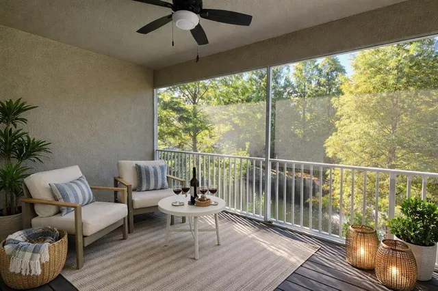 a view of an empty room with a window and a kitchen