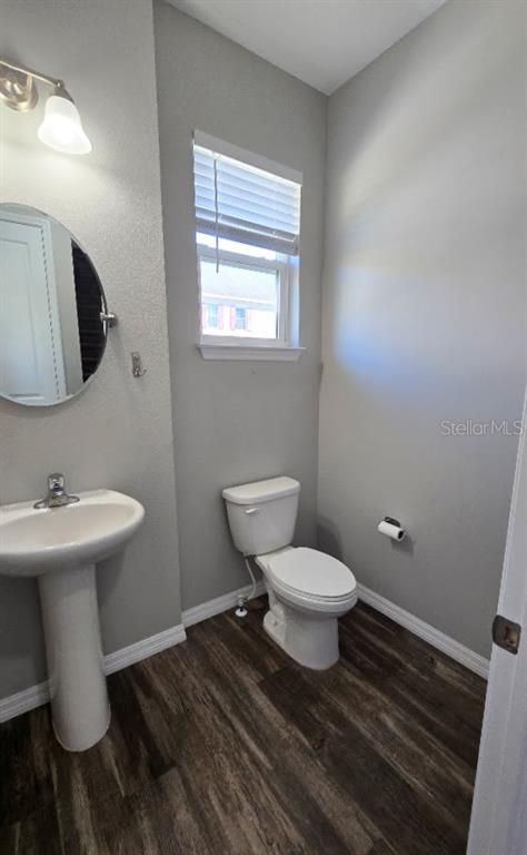 807 Callista Cay Loop Tarpon Springs, FL 34689 - Photo 16 of 32 a bathroom with a sink toilet and a mirror