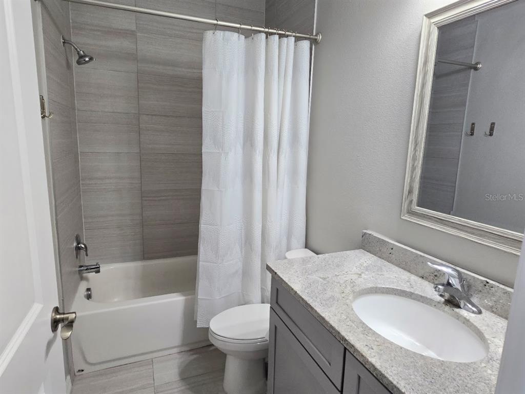 807 Callista Cay Loop Tarpon Springs, FL 34689 - Photo 25 of 32 a bathroom with a granite countertop sink toilet and shower