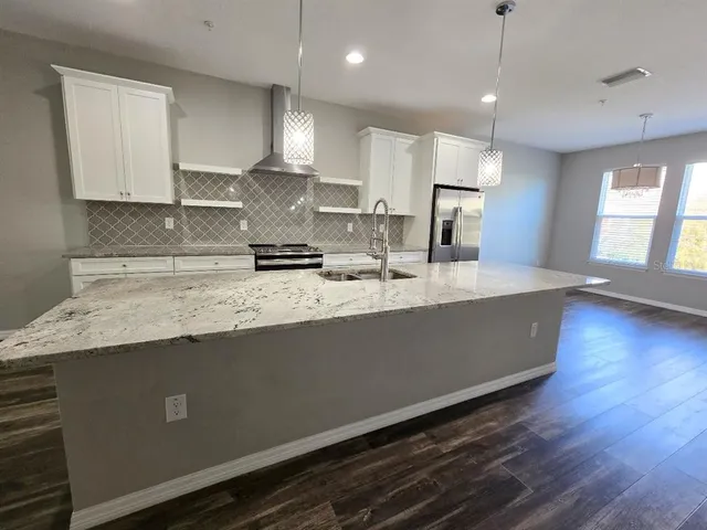 a kitchen with sink microwave and stove
