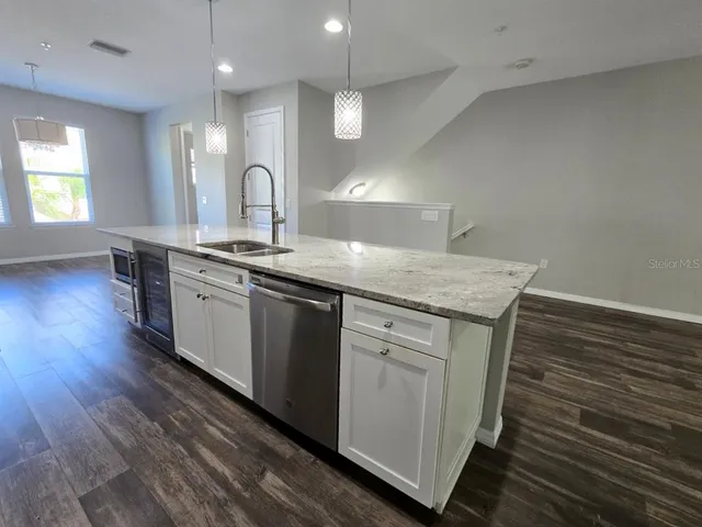a kitchen with a stove oven and sink