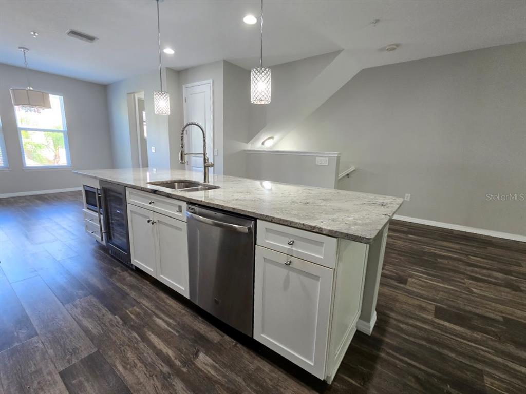 807 Callista Cay Loop Tarpon Springs, FL 34689 - Photo 7 of 32 a kitchen with sink microwave and stove