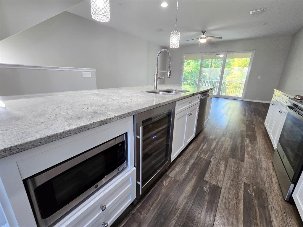 807 Callista Cay Loop Tarpon Springs, FL 34689 - Photo 8 of 32 a kitchen with a stove oven and sink