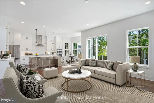 a kitchen with stainless steel appliances kitchen island granite countertop a table chairs in it and wooden floors