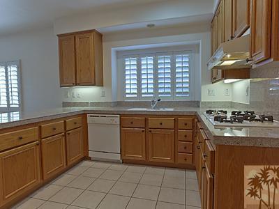 5 White Sun Way Rancho Mirage, CA 92270 - Photo 11 of 24 a kitchen with cabinets appliances a sink and a window