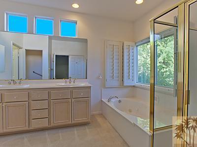5 White Sun Way Rancho Mirage, CA 92270 - Photo 15 of 24 a bathroom with a tub sink and mirror