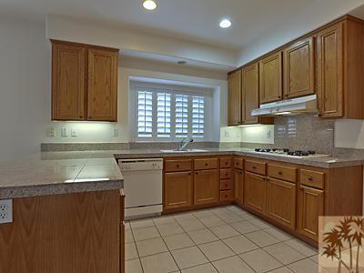5 White Sun Way Rancho Mirage, CA 92270 - Photo 10 of 24 a kitchen with granite countertop cabinets stainless steel appliances a sink and a window