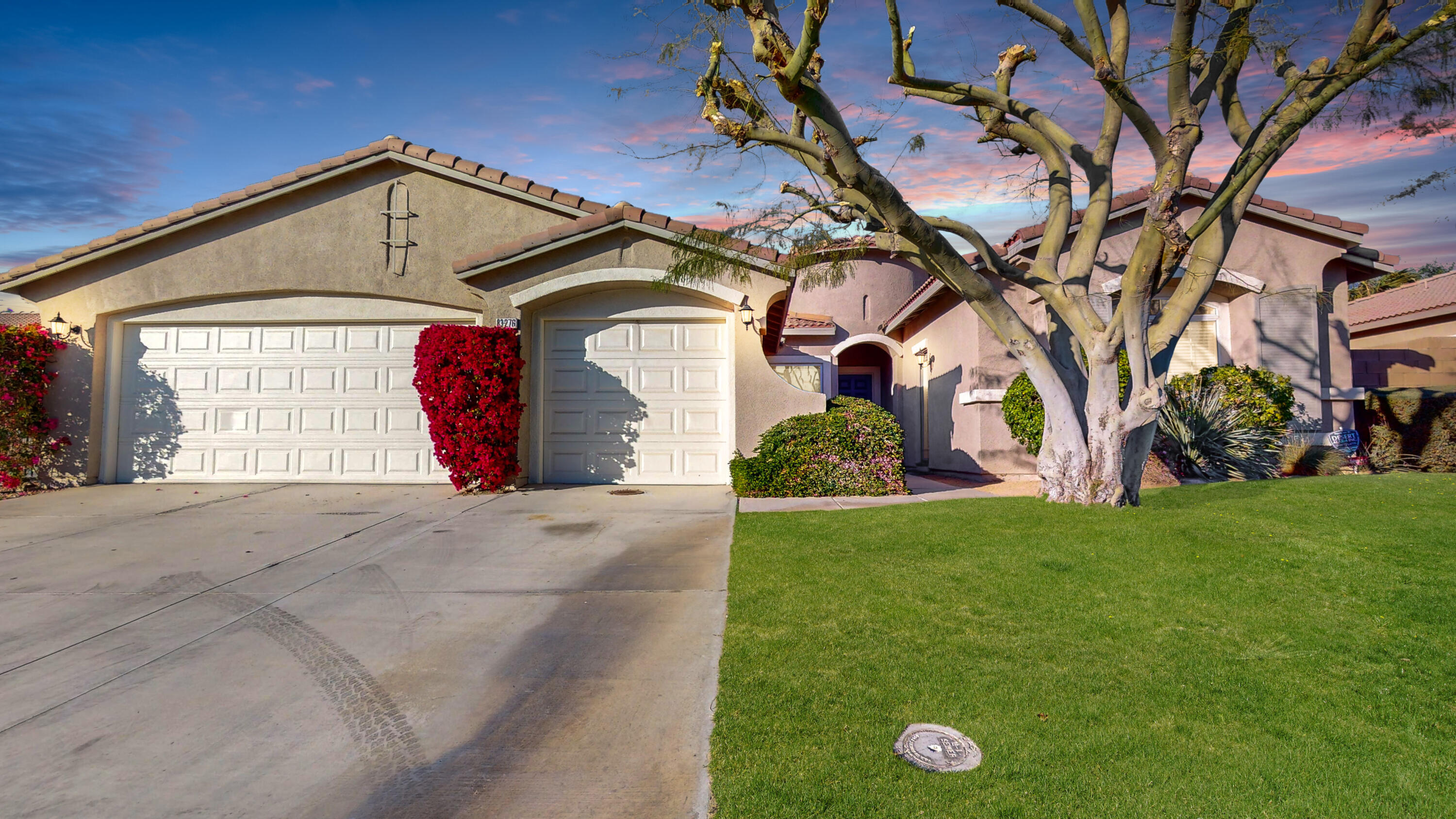 83276 Greenbrier Drive Indio, CA 92203 - Photo 2 of 12 a front view of a house with garden
