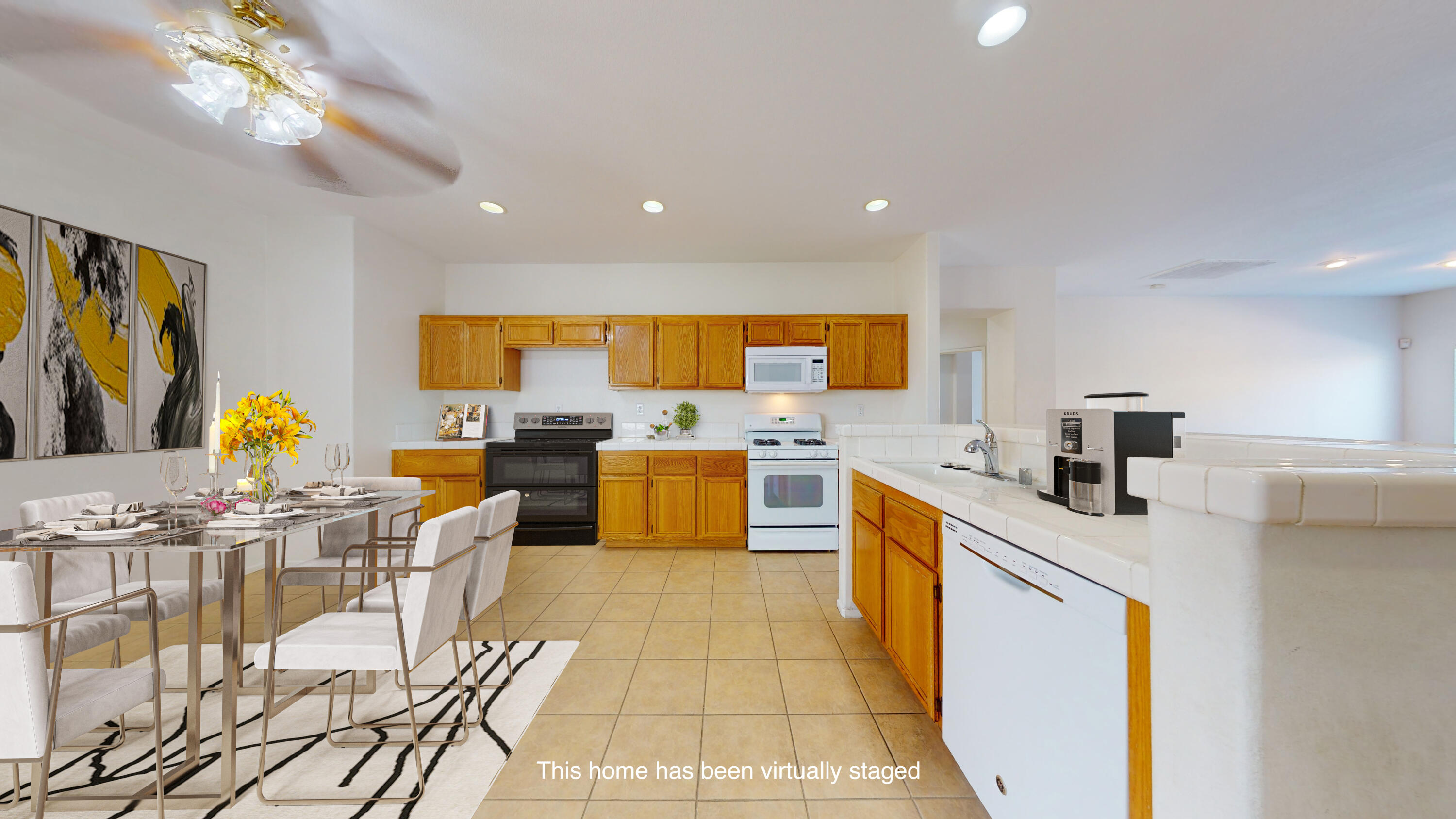83276 Greenbrier Drive Indio, CA 92203 - Photo 4 of 12 a kitchen with stainless steel appliances kitchen island granite countertop a table and chairs in it