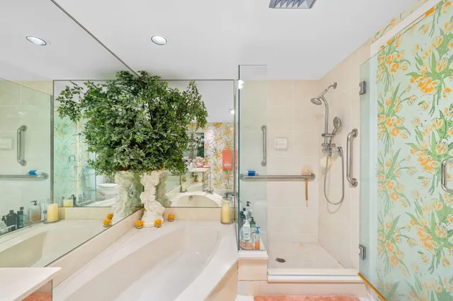 a view of a white house with a yard and potted plants