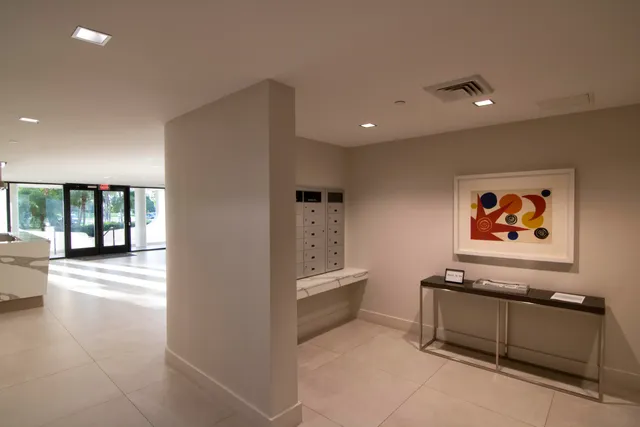 an aerial view of a house with a yard and lake view in back