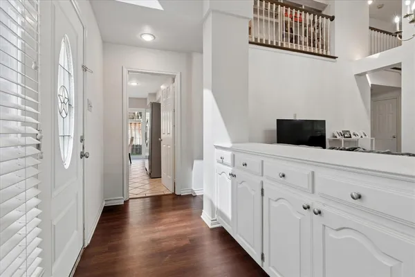 a hallway with white cabinets