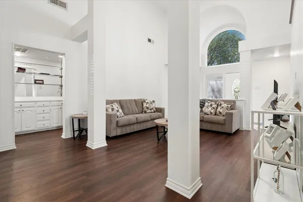 a living room with furniture and a wooden floor